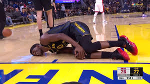 Warriors' Jimmy Butler helped off court with knee injury after awkward landing