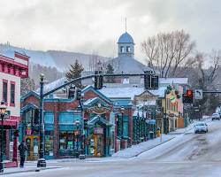 Image of Breckenridge, Colorado's main street with historic buildings and skiers/snowboarders