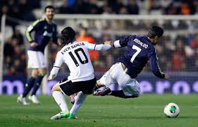 Cristiano Ronaldo being tackled by Ever Banega, in Valencia vs Real Madrid, in 2013. Real Madrid line-up vs Valencia: Goalkeeper: Iker Casillas - cristiano-ronaldo-624-being-tackled-by-ever-banega-in-valencia-vs-real-madrid-in-2013