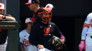 Craig Albernaz puts on catcher's mask and glove
