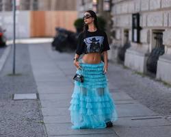 Image of slightly older girl wearing fashionable blouse and skirt in city setting
