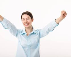 Image of person celebrating a victory with raised arms and a beaming smile