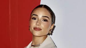 Olivia Culpo wearing a 49ers coat in support of McCaffrey