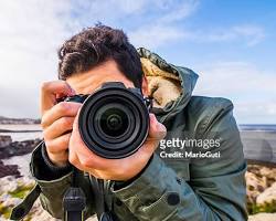 Image of person taking a photo with a camera