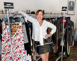 woman standing in front of a luxury resale shopの画像