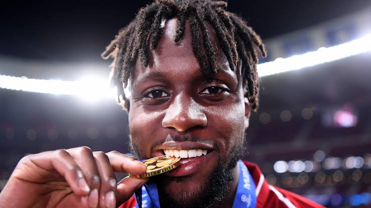 Divock origi bites champions league medal