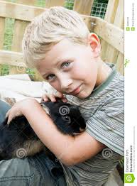 Boy cuddling up with pet rabbit - boy-cuddling-up-pet-rabbit-blond-youngster-his-best-friend-playing-outdoors-snuggling-huddling-cute-black-dwarf-32965129