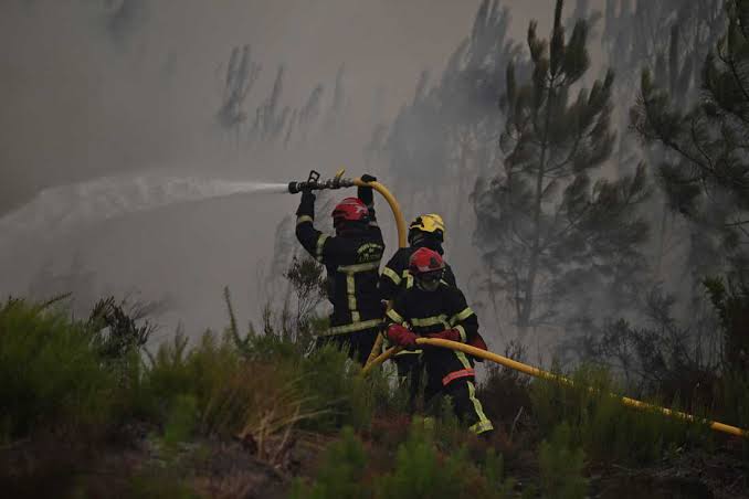 Exhausted firefighters continue to battle wildfires that force over 300,000 to flee homes in both France and Spain