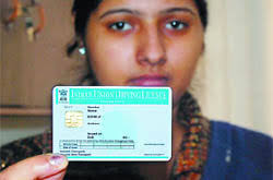 A staff shows a blank smart card driving licence at the printing laboratory in the office of District Transport Officer in Bathinda on Thursday. - bt2