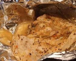 Изображение: Chicken wrapped in aluminum foil and baking in the oven