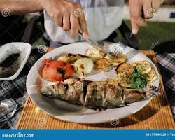 Image of Mediterranean restaurant with grilled fish and vegetables