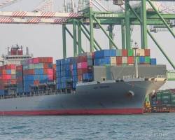 container ship sailing under the Bay Bridge