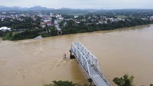 Flooding sweeps away a bus and a bridge collapses in Vietnam as storm 
deaths rise to 59