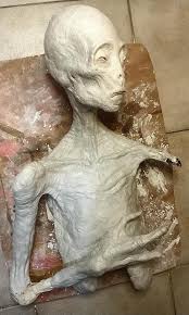 I'm working on a mummified alien sculpture made of air-drying clay, but it's still a work in progress. What do you think so far? Any suggestions or thoughts on how it's coming