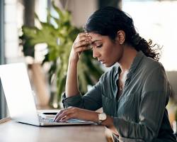 Image of someone looking stressed while holding a rent increase notice
