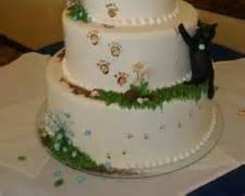 dog and a cat with a wedding cakeの画像