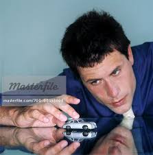 Stock Photo - Man Playing With Toy Car. Man Playing With Toy Car Stock Photo - Premium Rights-Managed, Artist: Andrew. Other searches that found this image: - 700-00193808em-Man-Playing-With-Toy-Car---