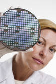 Woman with Silicon Wafer. Corbis PhotosRF Royalty Free - 42-15530452