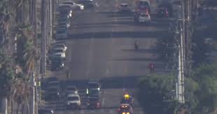 Police are in pursuit of a dirt bike rider armed with a gun in South Los Angeles