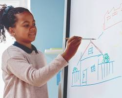 Image of student sketching an idea on a whiteboard, not copyrighted