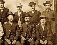 Image of crowd of townspeople cheering as Luke Short returns to Dodge City, accompanied by Bat Masterson and his posse