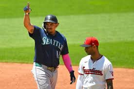 Seattle\'s Josh Naylor celebrates beside Guardians shortstop Brayan Rocchio after hitting an RBI double Sunday in Cleveland.