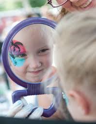 Valerie Flynn, 3, looks in the mirror at her new face paint during Fishers Oktoberfest at Saxony, Saturday, Sept. 28, 2013. Alex Farris - artandfests03
