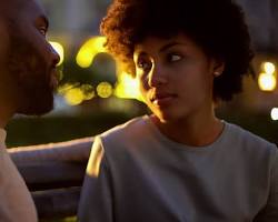 Image of couple looking into each other's eyes with a hopeful expression