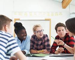 Image of Group of students working on a project together in a classroom