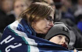 ... during a celebration of life ceremony for Seattle Mariners broadcaster Dave Niehaus. (AP) Sherry Locke of Federal Way, Wash. embraces her son Brandon, ... - 2706211589