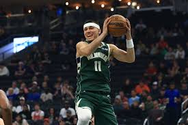 Houston Rockets and Milwaukee Bucks players battling for a rebound