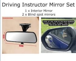 Image of student inside a car, adjusting the side mirror with the instructor's guidance