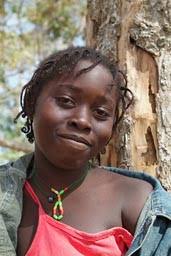 Daughter of Marie Toure, face of African girl, red blouse, jeans jacket, - jemberem-canamina-daughter-1