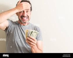 Image of someone looking stressed while holding a dollar bill