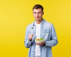 Image of person smiling and holding a healthy meal