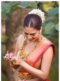 Malavika Mohanan stuns in red saree and glam fits