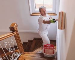 Image of homeowner reviewing a painter's portfolio