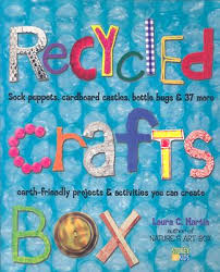 The image shows the cover of Recycled Crafts Box by Laura C. Martin. The title and author details are displayed in colorful, playful letters, with various craft materials on a bright, bubble wrap background.