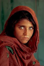 National Geographic photo representing contrast between dark hair and green eyes. - dark