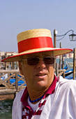 venice venezia italy gondola driver red straw hat for tourists grand canal mr italian portrait gondalier boat romantic water ride travel tourist holiday ... - kd3266