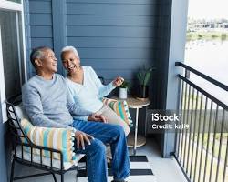 Image of happy senior couple sitting on their porch