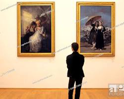 person admiring a painting in a museum