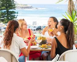 people enjoying a meal at a restaurant on Campbell Parade in Bondi Beach