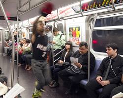 Image of person breakdancing on a New York City subway train