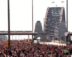 crowd of people walking across Sydney Harbour Bridge