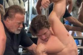 Arnie and love child son Joseph spotted working out together at muscle gym