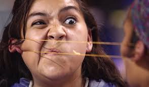 Vanessa Tahbone grimaces while competing against Nicole Colbert during the ear pull event at the 49th Annual World Eskimo-Indian Olympic Games July 23 at ... - ear-pulling