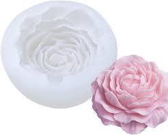 Image of large sculptural candle in the shape of a blooming rose, capturing the delicate beauty of the flower