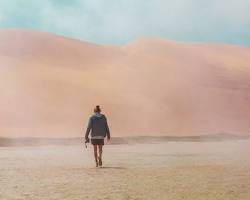 Image of person walking through a desert, never giving up