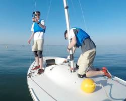Image of Spinlock Foil sailing vest being worn by a person on a sailboat